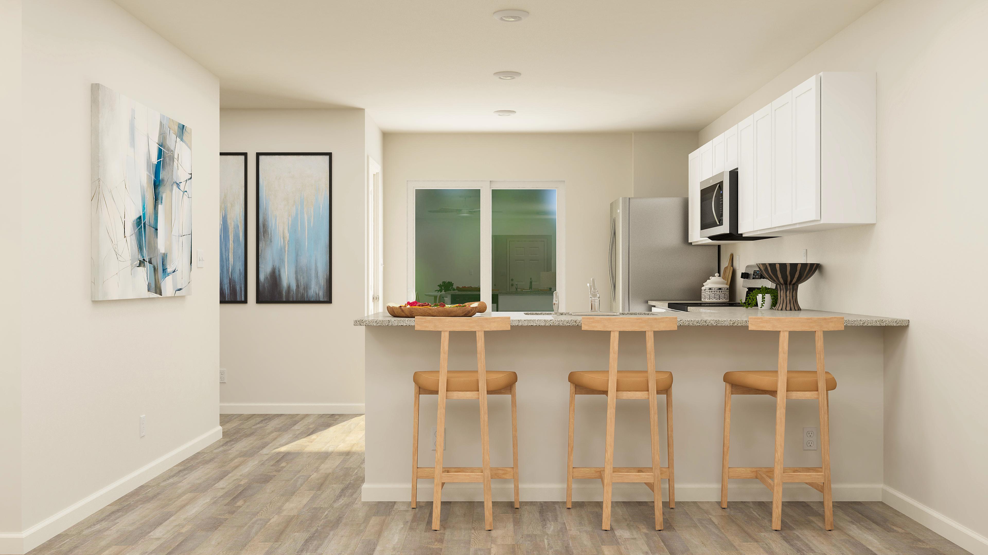 A kitchen with stools and a table.