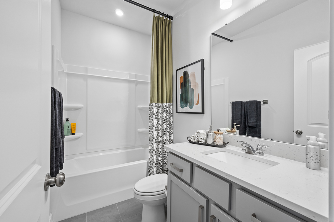 A bathroom with a tub sink and toilet.