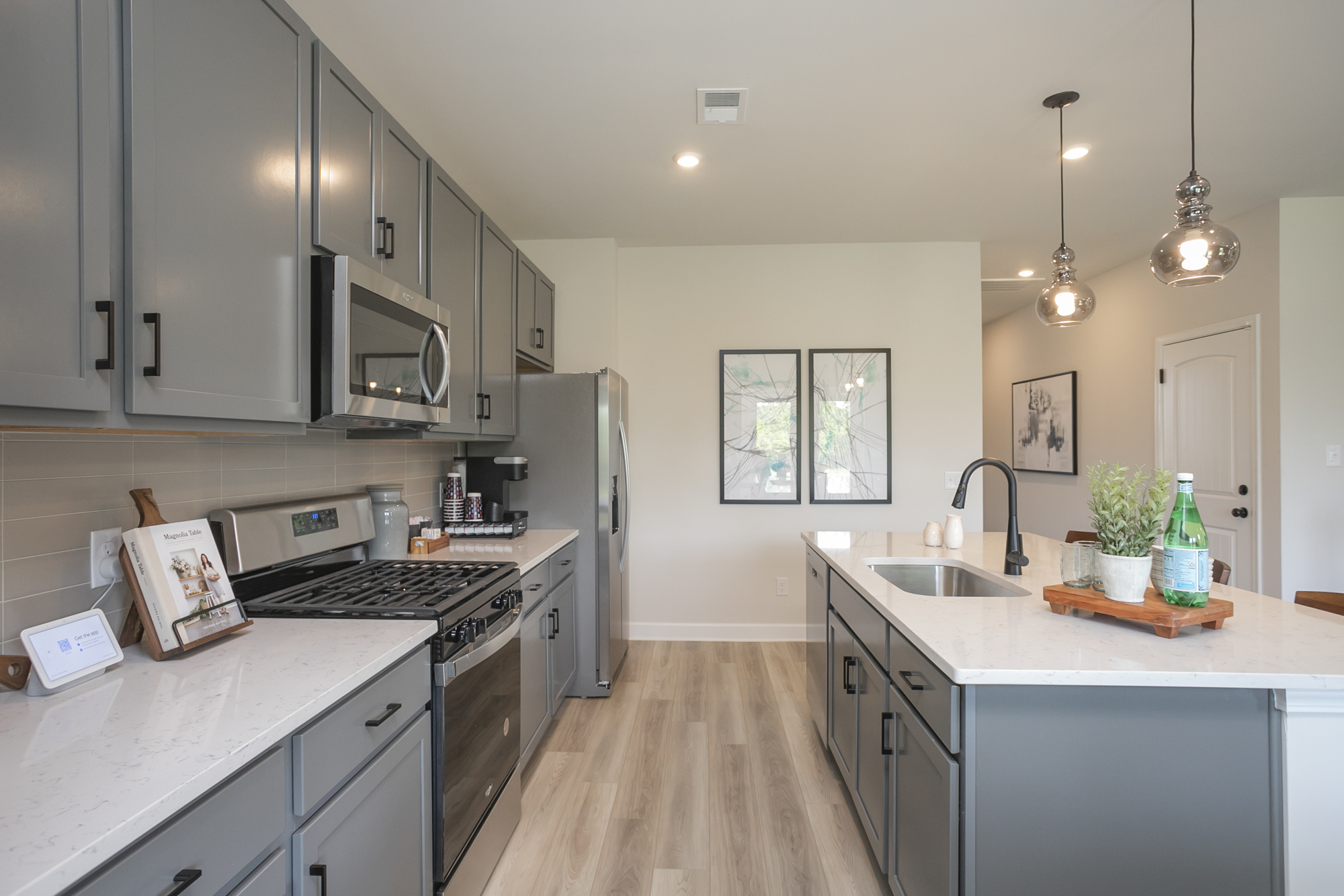A kitchen with white cabinets.