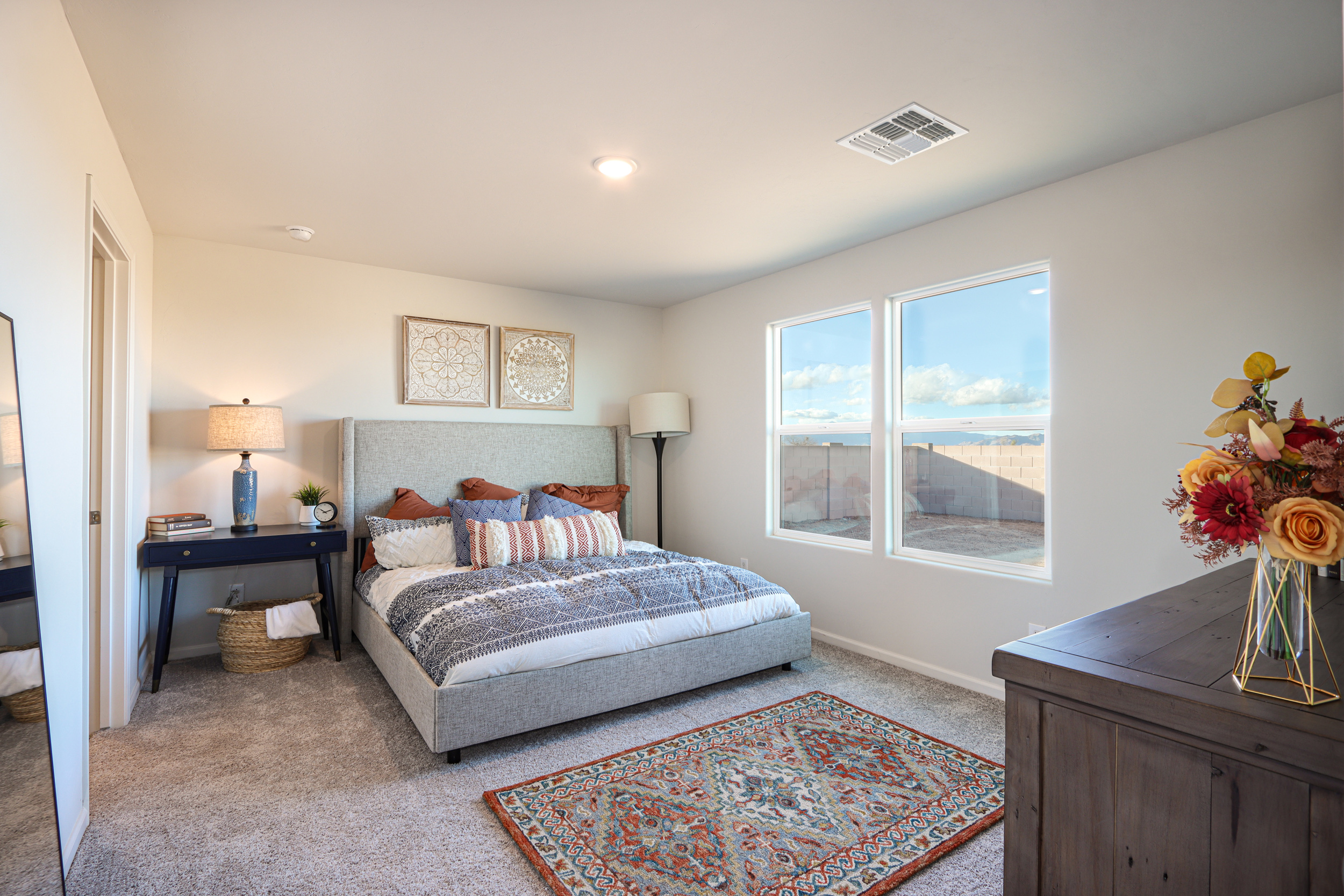 A bedroom with a large window.