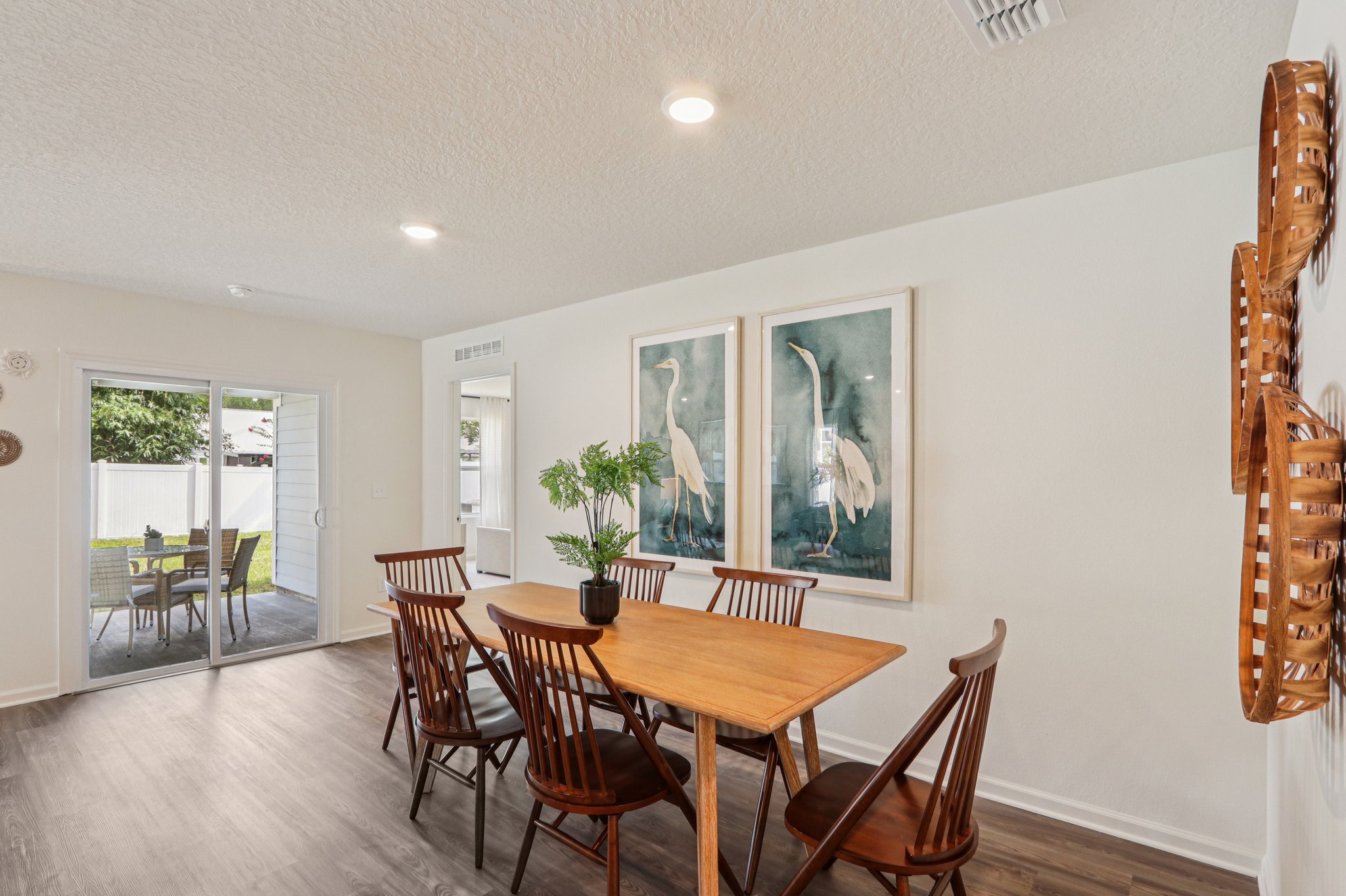 A dining room with a table and chairs.
