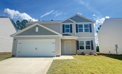 A house with garages and grass.