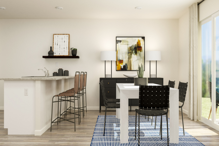 A dining room with a table and chairs.